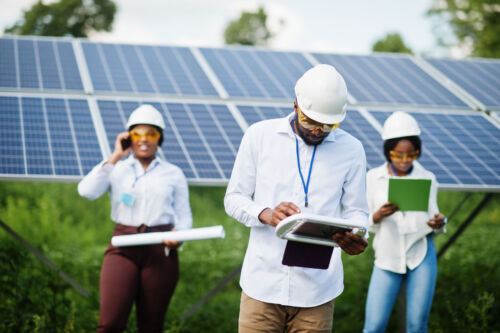 Showcasing our Angolan team of PV solar installation staff with a solar panel in the background. Committed to clean energy solutions.