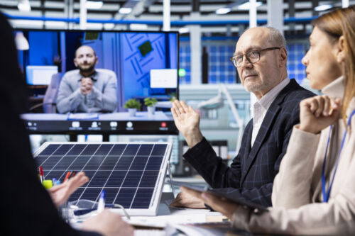 Factory managers on a video call discussing new photovoltaic materials.